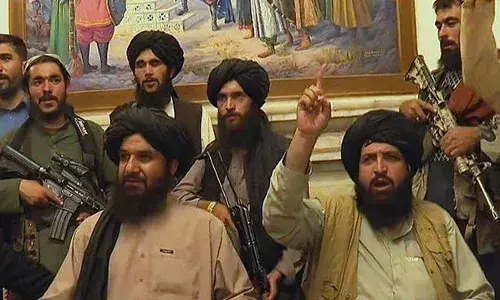 Taliban fighter poses in front of bookshelf where Amrullah Saleh recorded message, picture goes viral