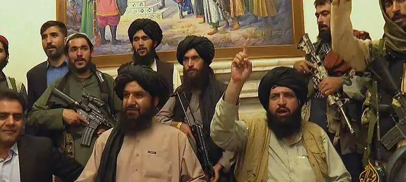 Taliban fighter poses in front of bookshelf where Amrullah Saleh recorded message, picture goes viral